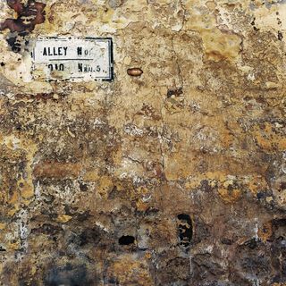 a wall with many layers of peeling brown paint